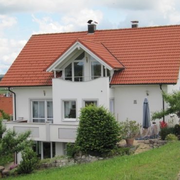 Wohnhaus mit farblich abgesetzten Fensterfaschen